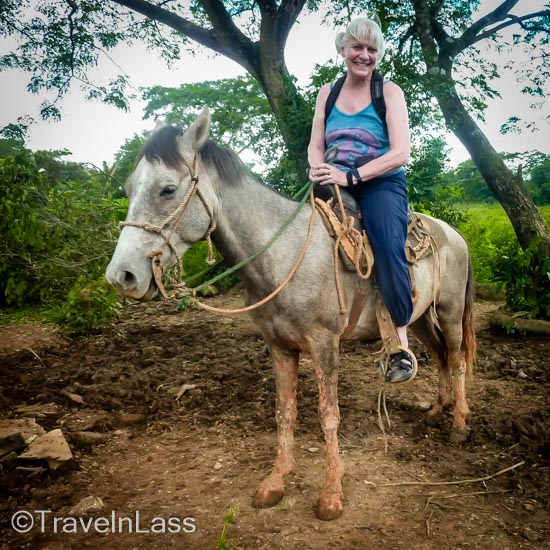 Aboard my magnificent (-ly short!) Cuban steed (note the mud past his KNEES!)