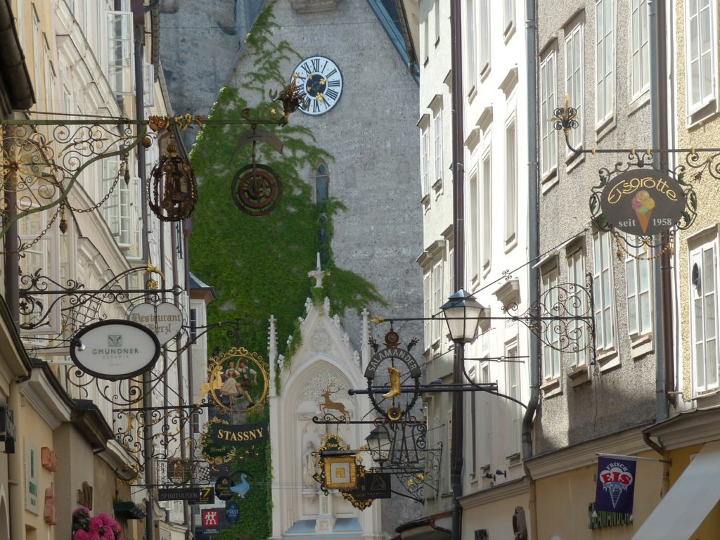 Charming "guild signs" hanging from every facade in Salzburg, Austria's "Getreidegasse" square.