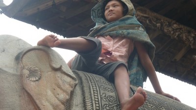 GirlOnStatueBhaktapur678x383 (First Impressions:  Nepal)