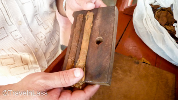 For uniformity, each rolled cigar is placed in a sized-press to dry