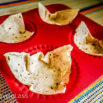 Place buttered tortilla triangles in muffin cups