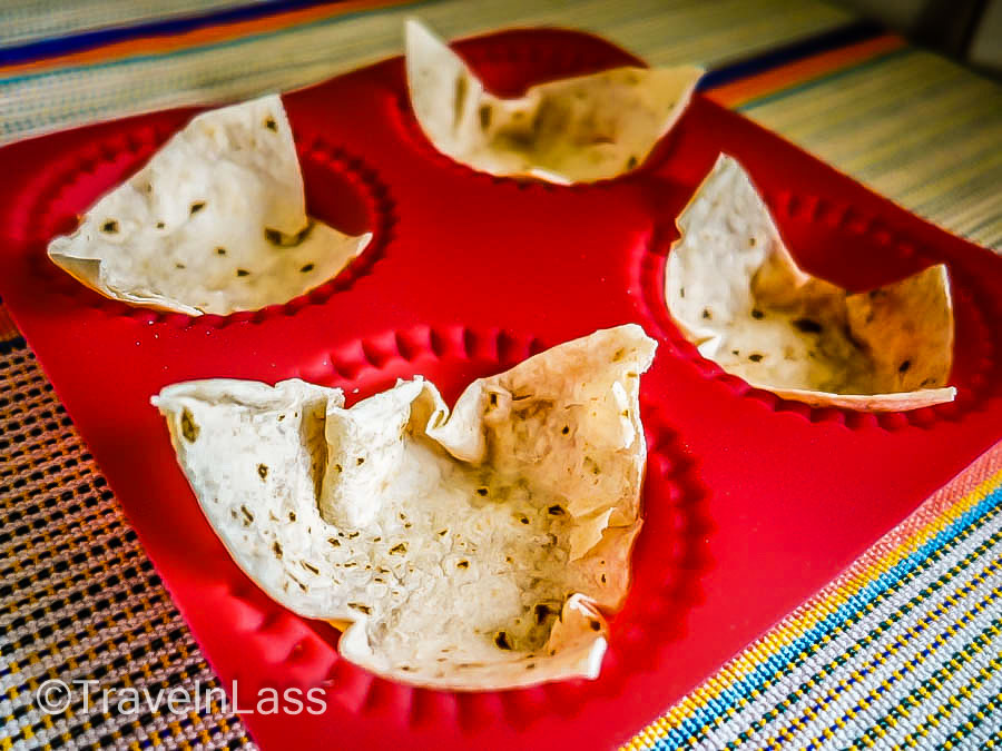 Place buttered tortilla triangles in muffin cups