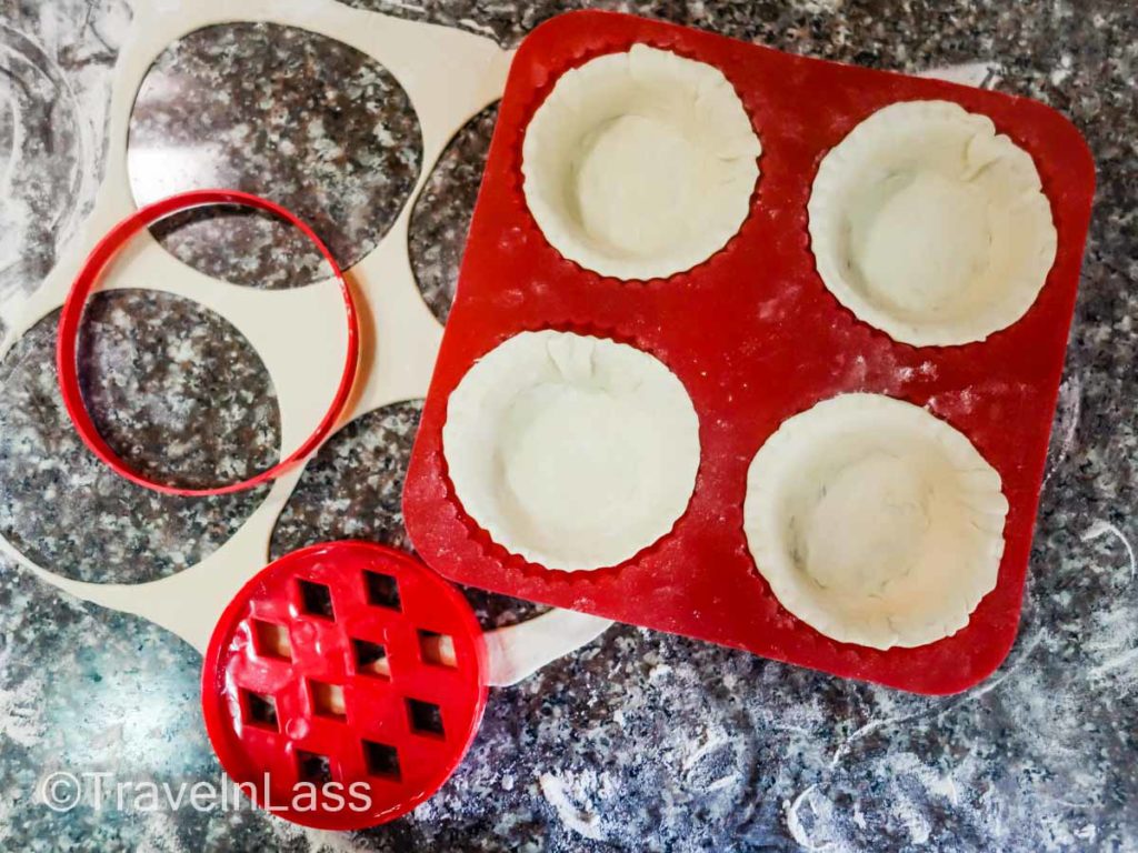 Cut small circles of dough and gently tuck them into the tart molds.