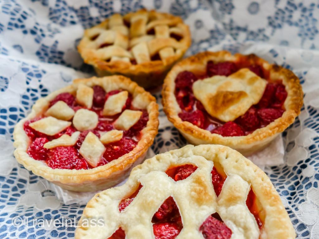 An assortment of freshly baked raspberry tarts.