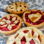 An assortment of freshly baked raspberry tarts. (Fresh Raspberry Tarts)
