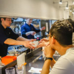 Passing out a streamy bowl of ramen to eager foodies (Japan Adventures: Tokyo – (Michelin Star) Tsuta Ramen)