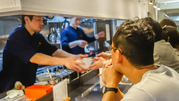 Passing out a streamy bowl of ramen to eager foodies