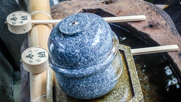 At most shrines and temples in Japan you'll find a "temizuya", a small fountain with bamboo ladles, or "shakushi"; all guests are expected to wash both hands and mouths to purify themselves before entering.