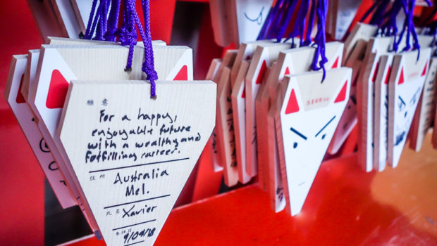 You can buy a small "Ema" board (Japanese wishing plaque) and write a wish to leave behind at the Fushima Inari shrine.